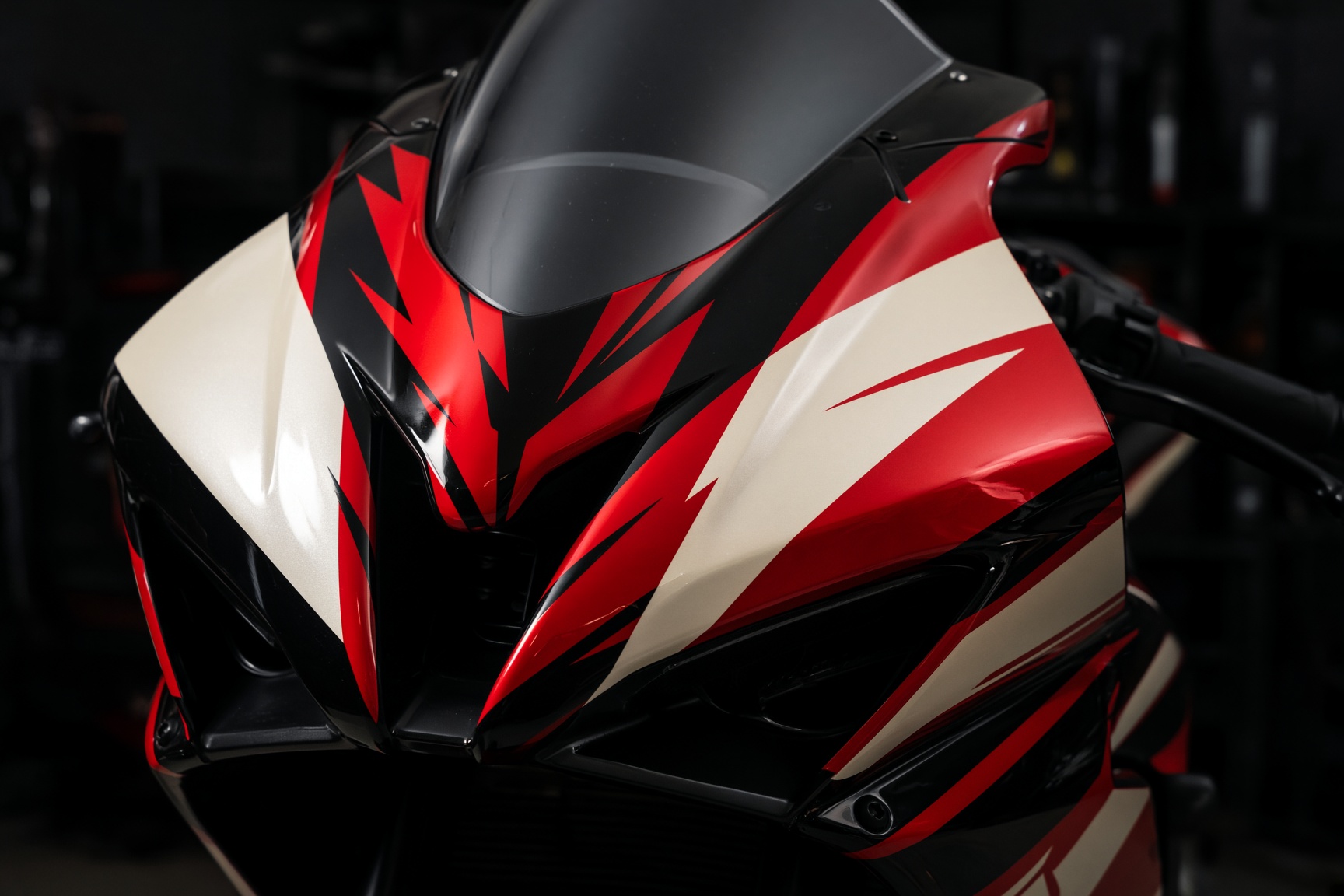 Sport motorcycle fairing finished with red and black vinyl graphics